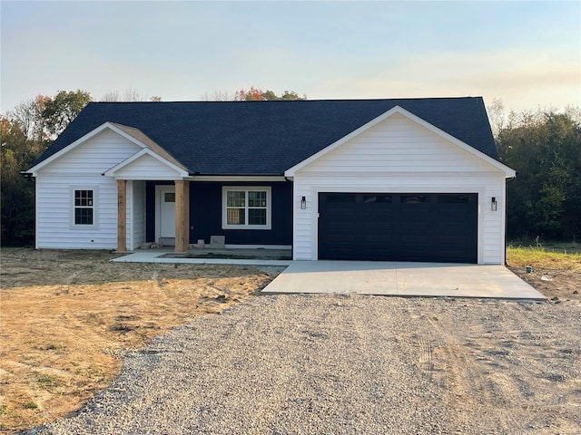 ranch-style home with covered porch and a garage