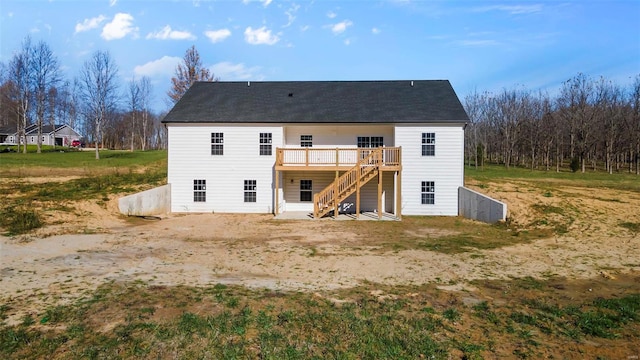 rear view of property featuring a wooden deck