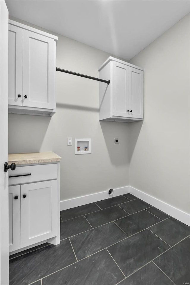 washroom with cabinets, hookup for a washing machine, dark tile patterned floors, and electric dryer hookup