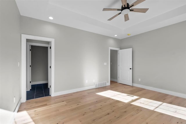 unfurnished bedroom with ceiling fan and light wood-type flooring