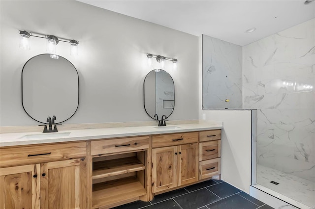 bathroom featuring tile patterned floors, vanity, and a tile shower