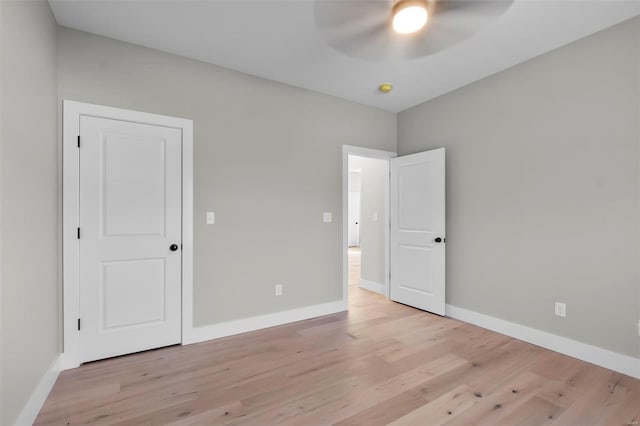 unfurnished bedroom with light hardwood / wood-style flooring and ceiling fan