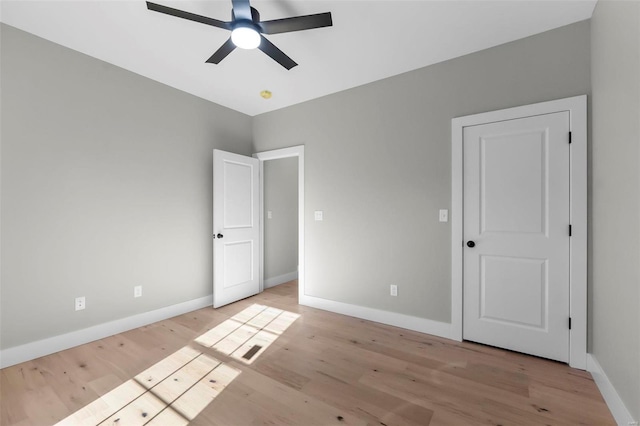 unfurnished bedroom with light wood-type flooring and ceiling fan