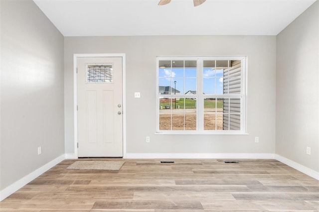 foyer with light hardwood / wood-style flooring and ceiling fan