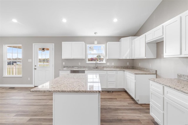 kitchen with sink, white cabinets, and plenty of natural light