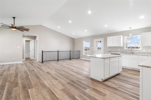 kitchen featuring white cabinets, a healthy amount of sunlight, and light hardwood / wood-style floors