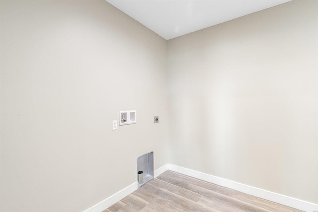 clothes washing area with washer hookup, hookup for an electric dryer, and light wood-type flooring