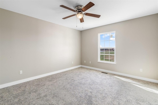 carpeted spare room with ceiling fan