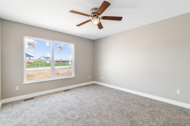 spare room featuring ceiling fan and carpet flooring