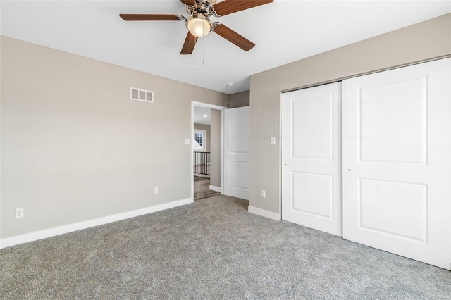 unfurnished bedroom featuring a closet, ceiling fan, and carpet flooring