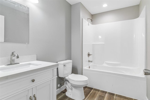 full bathroom featuring bathtub / shower combination, hardwood / wood-style floors, toilet, and vanity