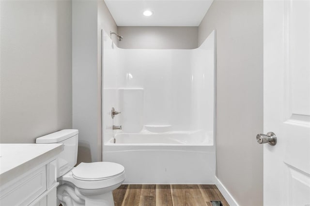 full bathroom featuring vanity, hardwood / wood-style floors, toilet, and shower / bathtub combination