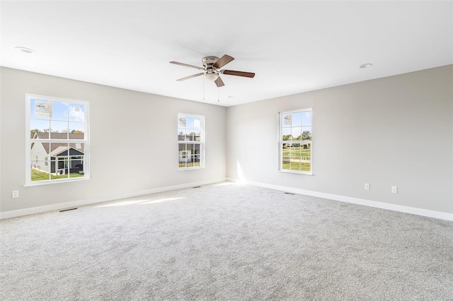 spare room featuring ceiling fan and carpet floors