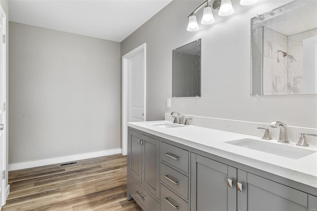 bathroom with vanity, walk in shower, and wood-type flooring