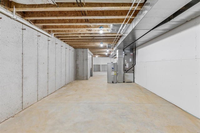 basement featuring electric water heater and heating unit