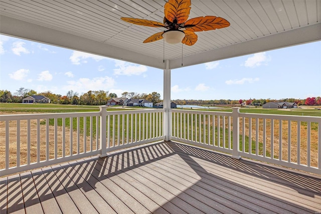 deck with ceiling fan and a lawn