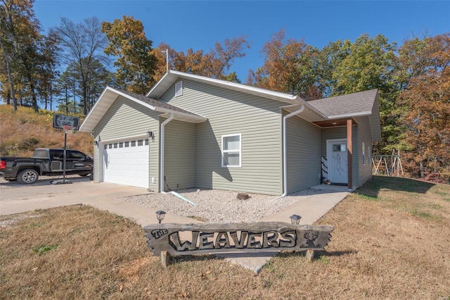 view of side of home featuring a garage and a lawn