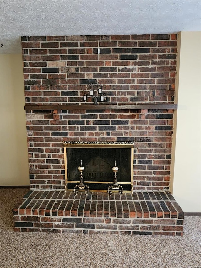 room details with carpet, a textured ceiling, and a fireplace