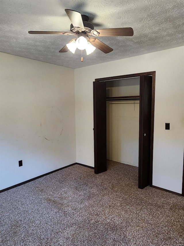 unfurnished bedroom with a closet, a textured ceiling, carpet flooring, and ceiling fan