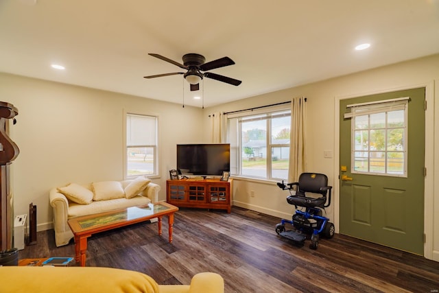 living room featuring dark hardwood / wood-style floors, ceiling fan, and a wealth of natural light