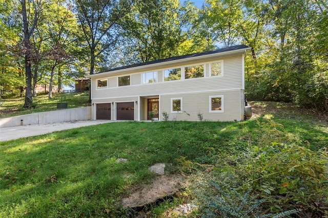 view of front of house with a front lawn and a garage