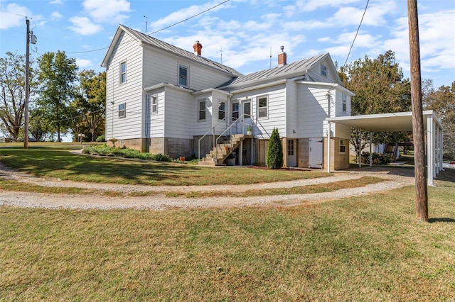 view of side of home with a yard and a carport