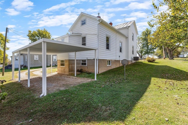 view of home's exterior with a yard and central AC