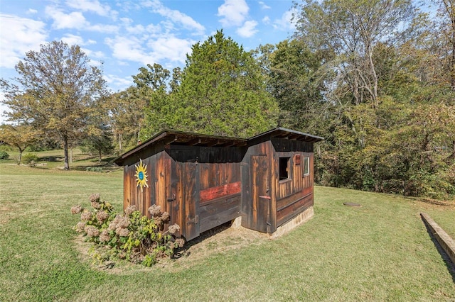 view of outbuilding with a lawn