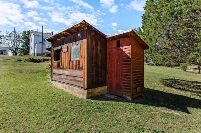 view of outbuilding featuring a lawn