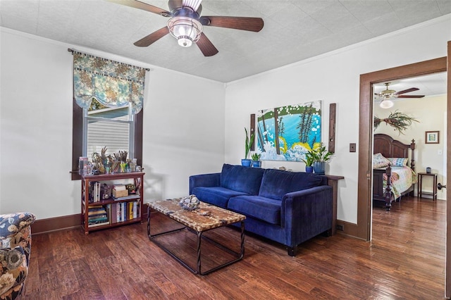 living room with ornamental molding, ceiling fan, and dark hardwood / wood-style flooring