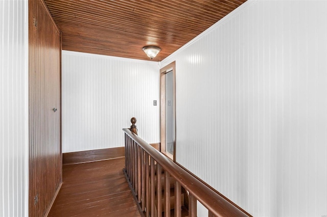 hallway featuring wood ceiling, dark hardwood / wood-style floors, and crown molding