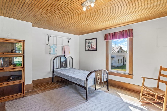 bedroom with wood ceiling and hardwood / wood-style floors