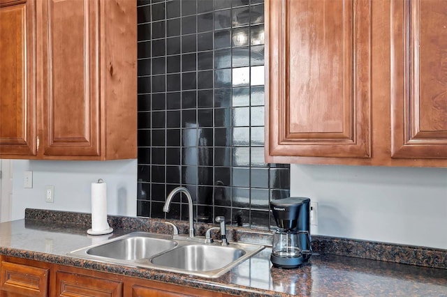 kitchen featuring sink and dark stone countertops