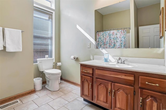 bathroom featuring vanity, toilet, and tile patterned flooring