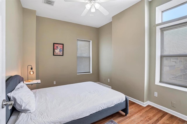 bedroom with ceiling fan and hardwood / wood-style floors