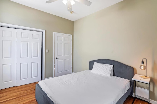 bedroom featuring hardwood / wood-style flooring, a closet, and ceiling fan