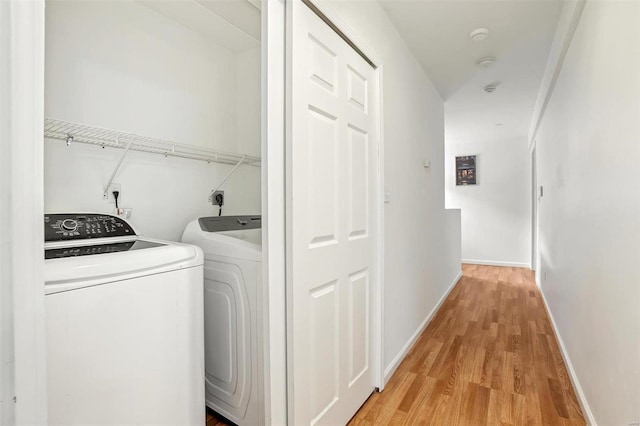 washroom featuring hardwood / wood-style floors and independent washer and dryer