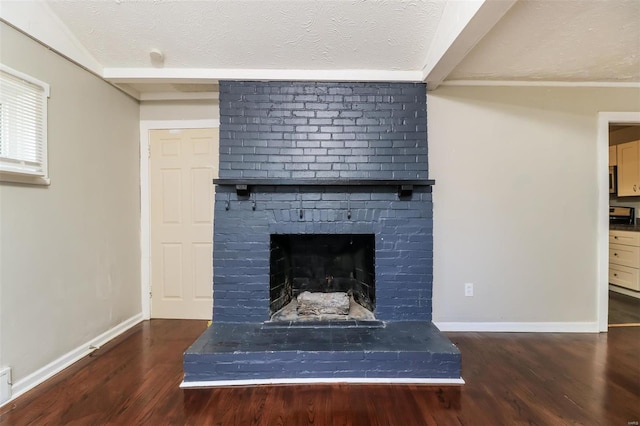 details with a textured ceiling, wood-type flooring, and a brick fireplace