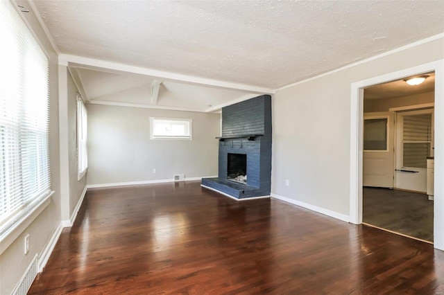 unfurnished living room featuring dark wood-type flooring, lofted ceiling with beams, a textured ceiling, and a fireplace