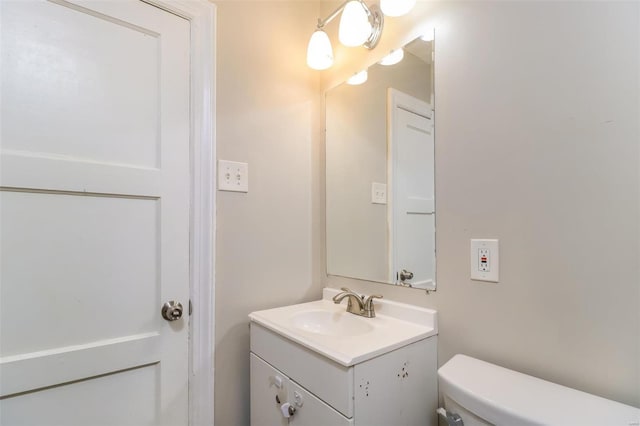 bathroom with toilet and vanity