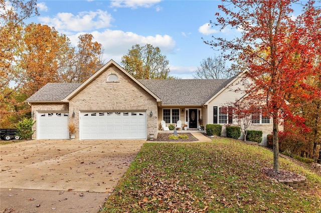 view of front of house featuring a garage, a shingled roof, concrete driveway, and brick siding