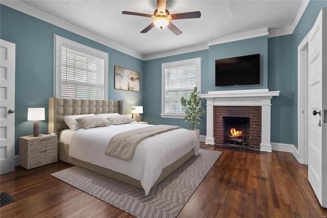 bedroom featuring ceiling fan, a fireplace, ornamental molding, and dark hardwood / wood-style floors