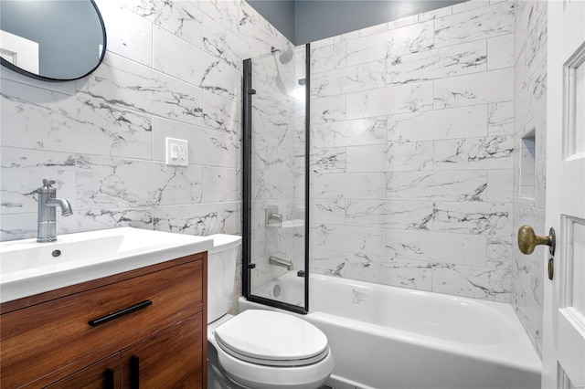 full bathroom with vanity, tiled shower / bath combo, and toilet