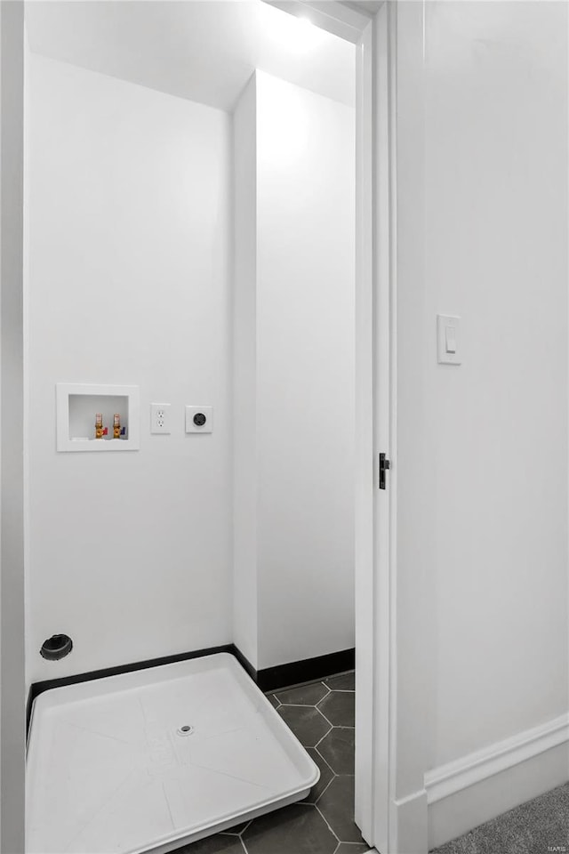 clothes washing area featuring dark tile patterned floors, hookup for an electric dryer, and washer hookup