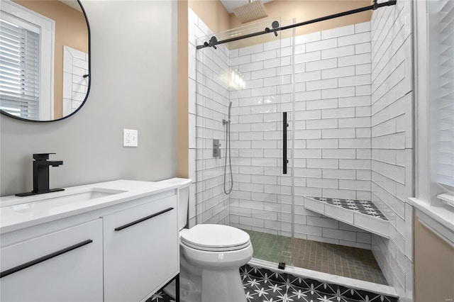 bathroom with vanity, toilet, and a shower with shower door