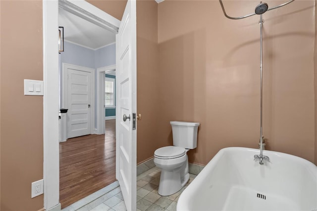 bathroom with toilet, wood-type flooring, and a washtub