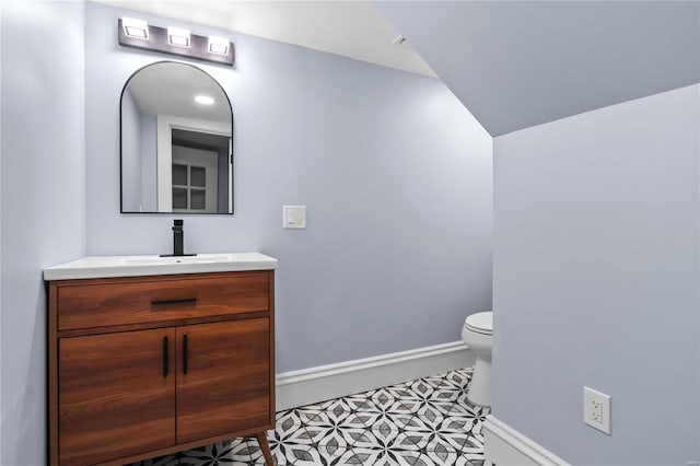 bathroom featuring vanity, toilet, and tile patterned flooring