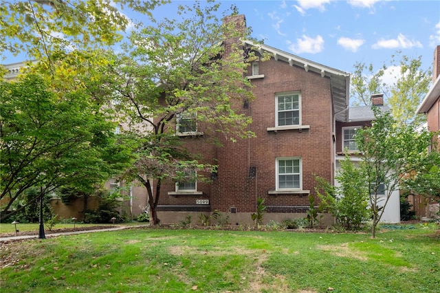 view of side of home featuring a yard