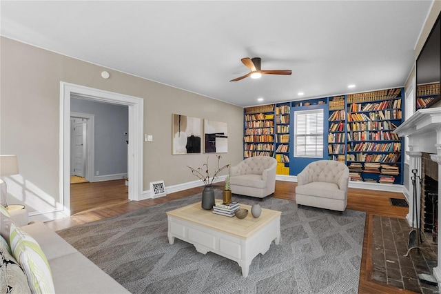 living room featuring ceiling fan and hardwood / wood-style flooring