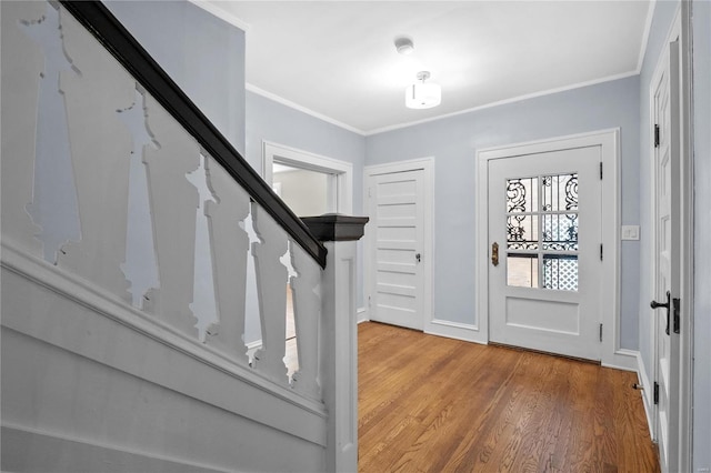 foyer entrance featuring hardwood / wood-style flooring and ornamental molding